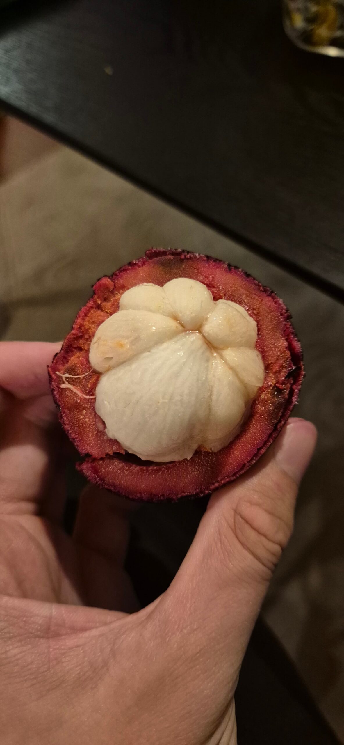 Aufgeschnittene Mangostane mit lila-roter Schaler und weißem Fruchtfleisch